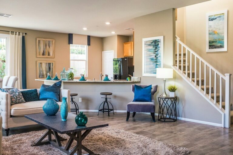 A living room with a sofa, coffee table, and open kitchen area