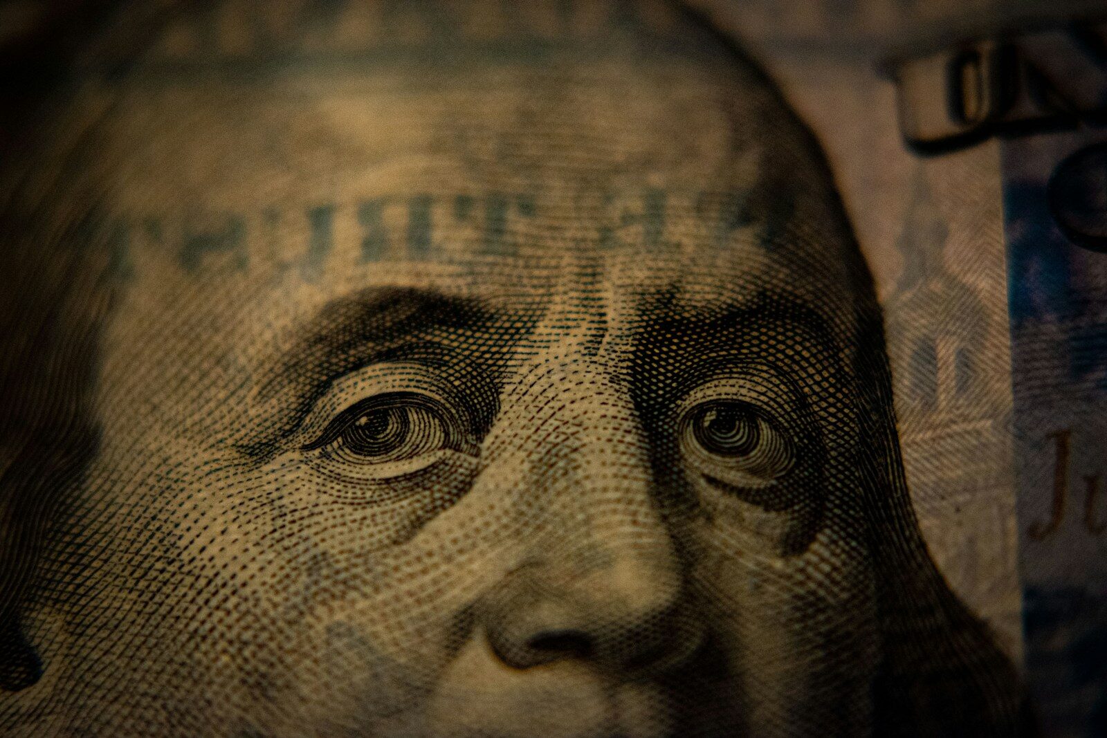Home A close-up of Benjamin Franklin on a United States one hundred dollar bill